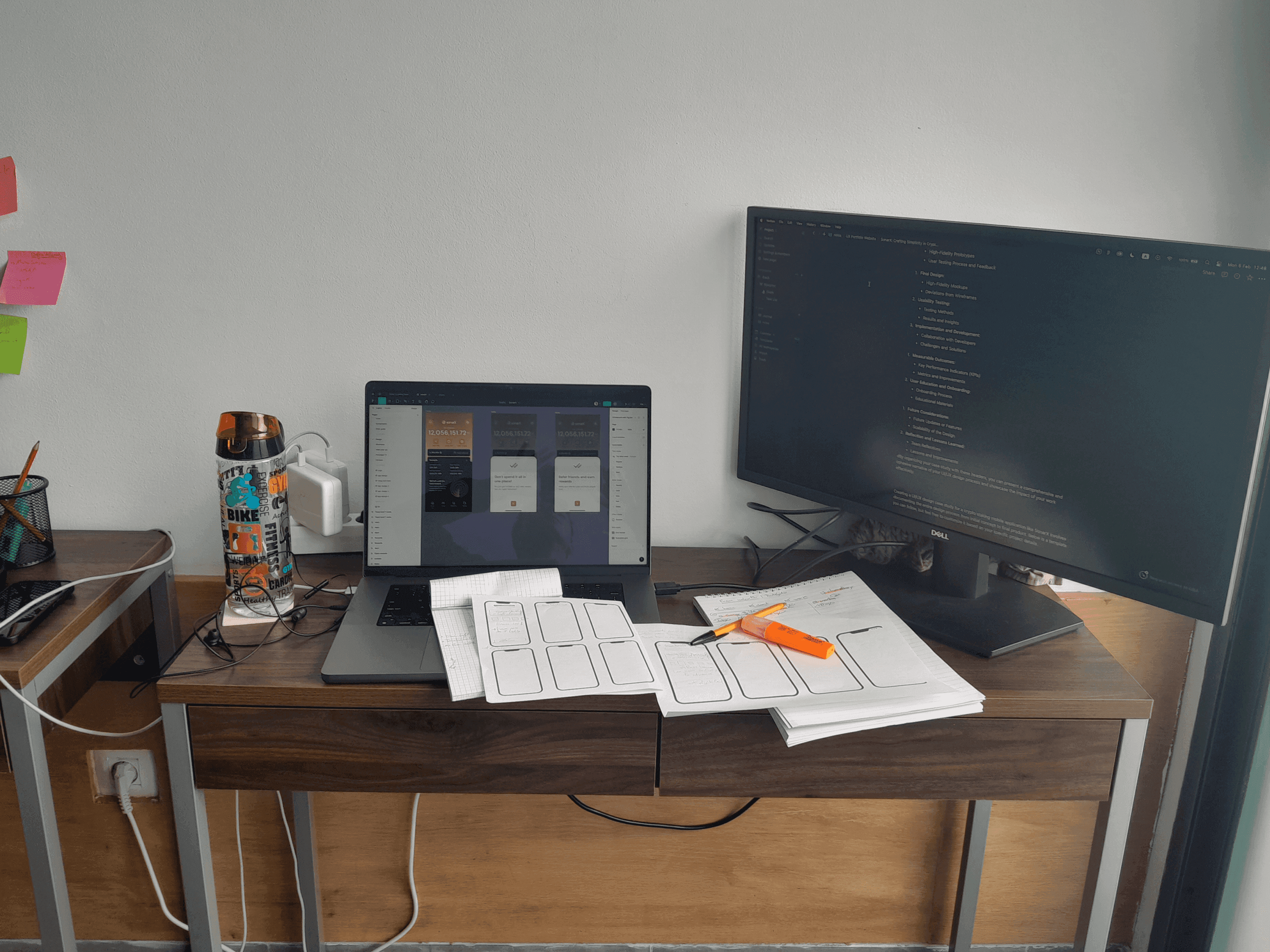 Desk with a laptop and printed wireframes during user research