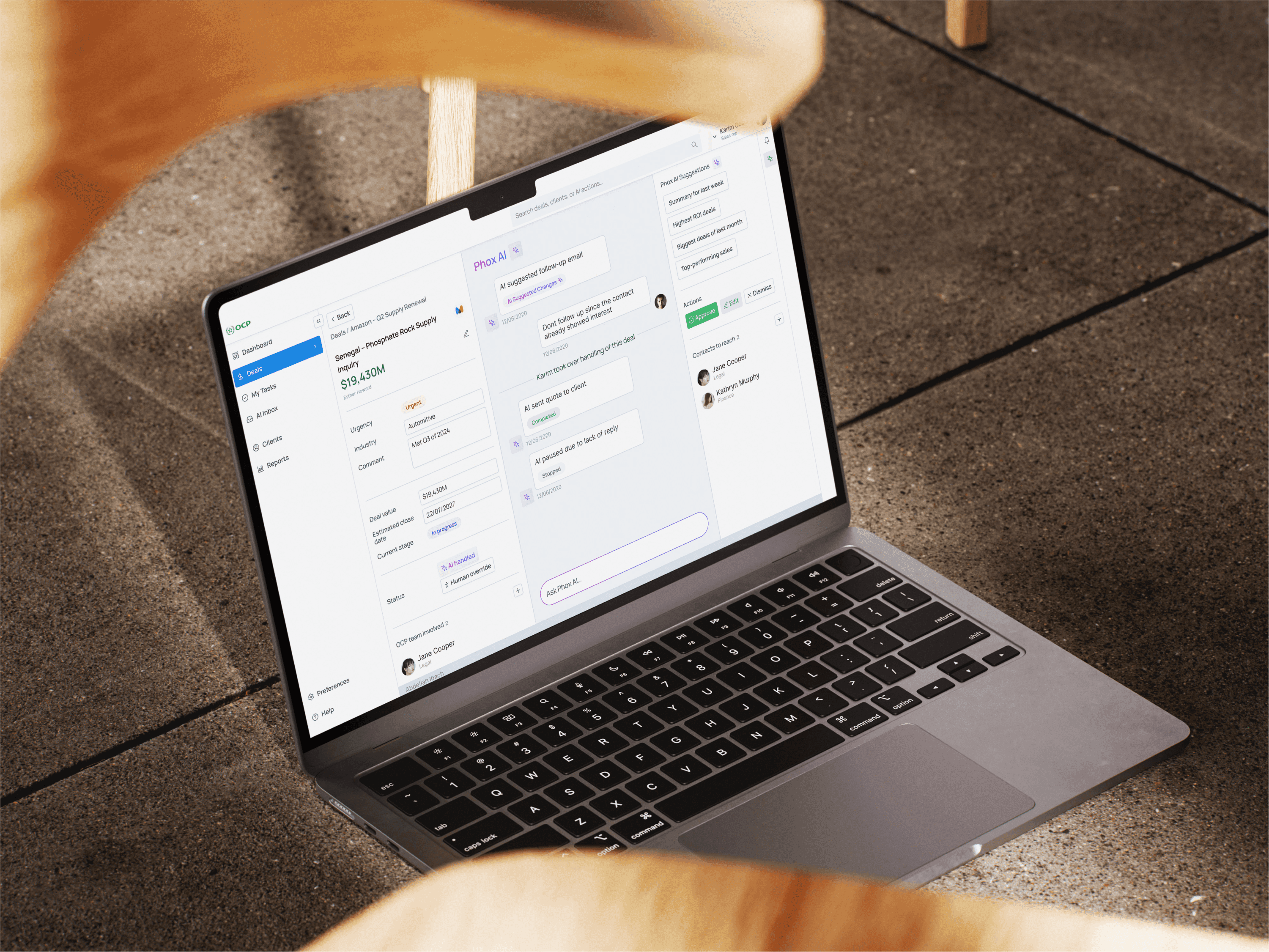 AI agent dashboard on a laptop, showing a deal record beside the AI panel